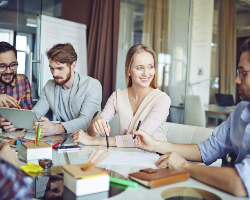 Modern business group discussing paper in office